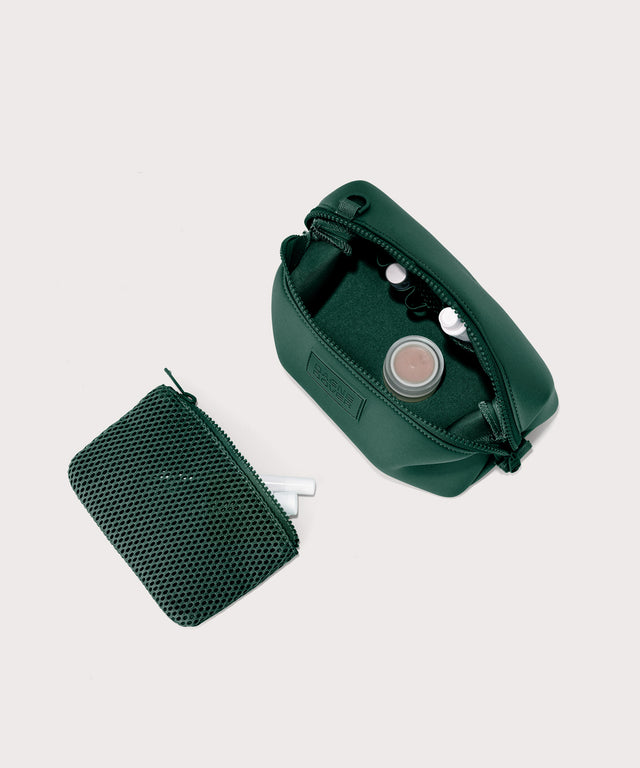 Hunter small toiletry bag in a saturated, jewel-toned deep green with bold blue undertones showing exterior airmesh pouch. Top down view.