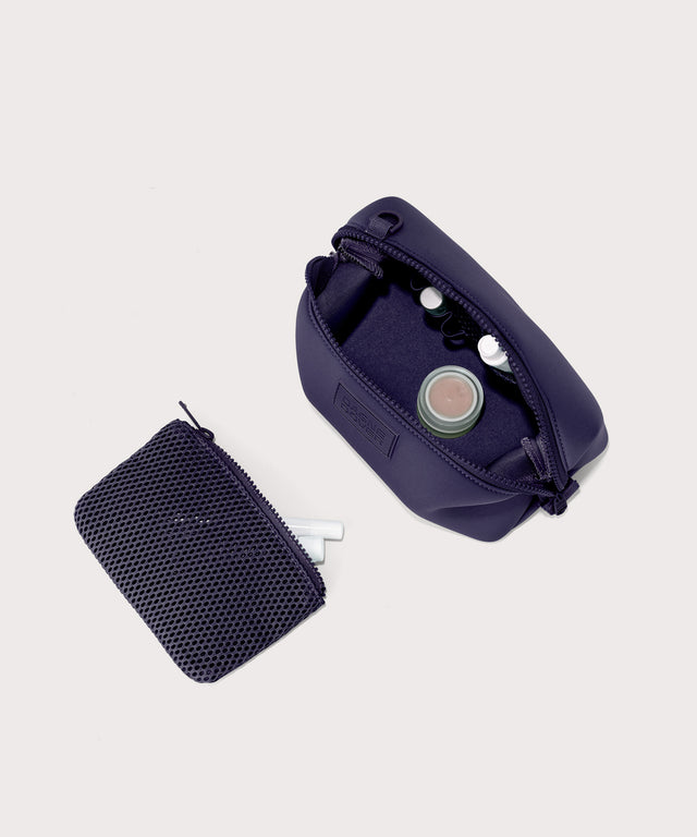 Hunter small toiletry bag in a jewel-toned, deep blue with strong purple undertones. showing exterior airmesh pouch. Top down view.