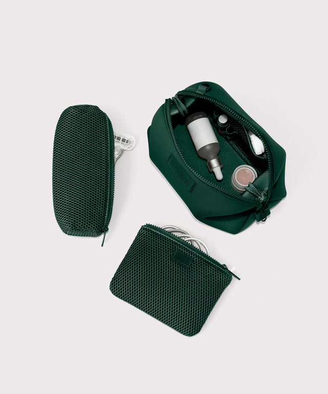 Hunter Large toiletry bag in a saturated, jewel-toned deep green with bold blue undertones unzipped, top down view.