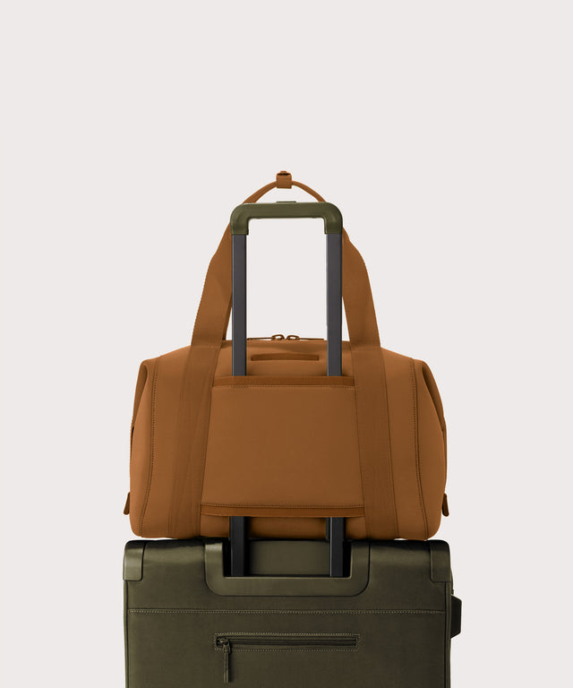 Large Landon Carryall in a a saturated, warm medium-brown with burnt orange undertones displaying luggage sleeve