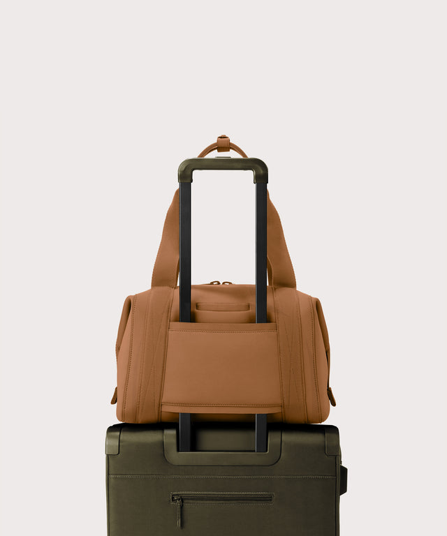 Medium Landon Carryall in a a saturated, warm medium-brown with burnt orange undertones displaying luggage sleeve