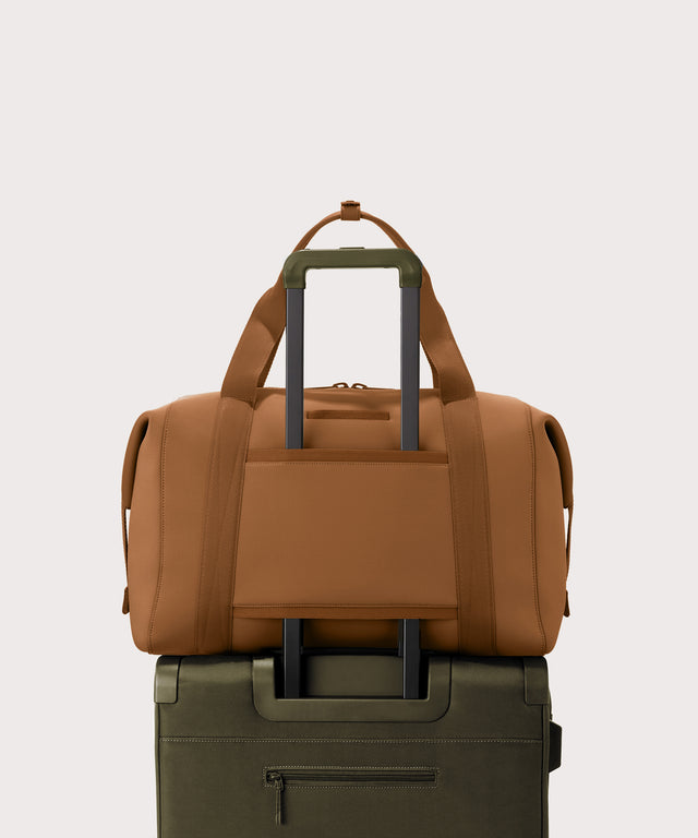 Extra Large Landon Carryall in a a saturated, warm medium-brown with burnt orange undertones displaying luggage sleeve
