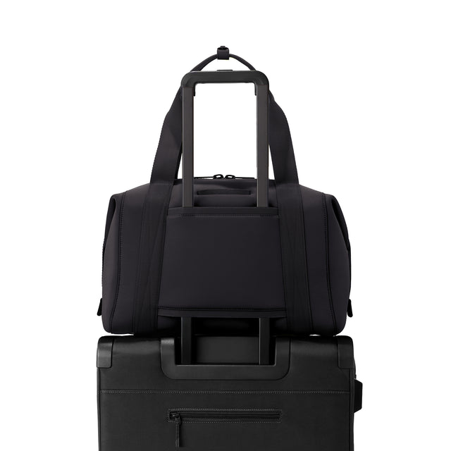 Large Landon Carryall in black displaying luggage sleeve