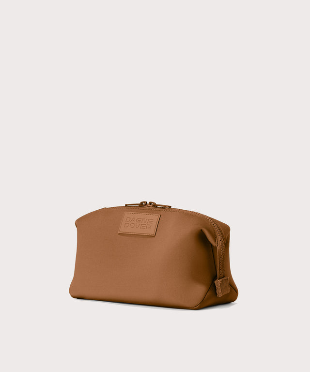 Hunter Large toiletry bag in a saturated, warm medium-brown with burnt orange undertones, side angle view