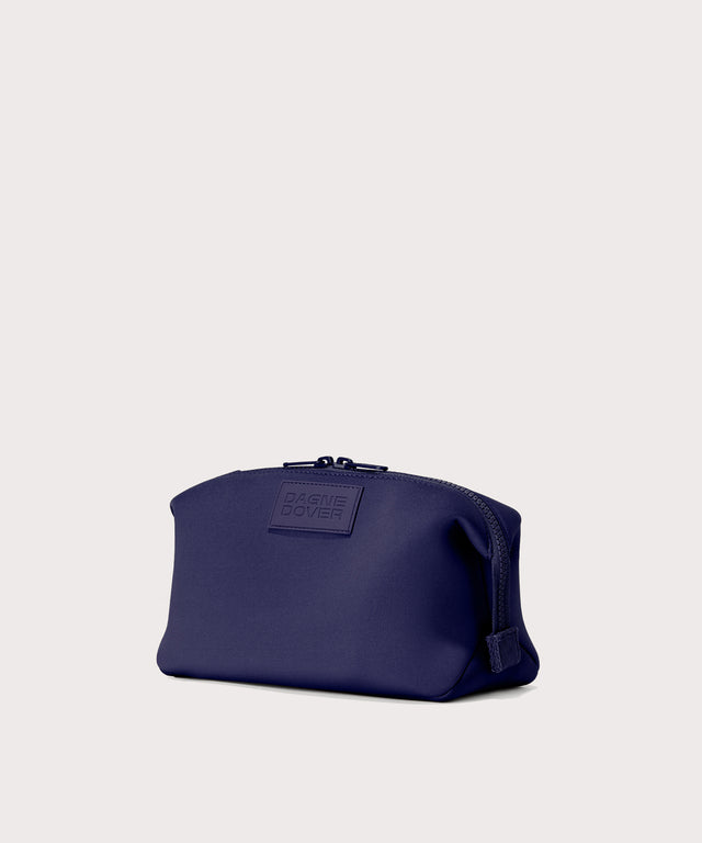 Hunter Large toiletry bag in  a jewel-toned, deep blue with strong purple undertones, side angle view