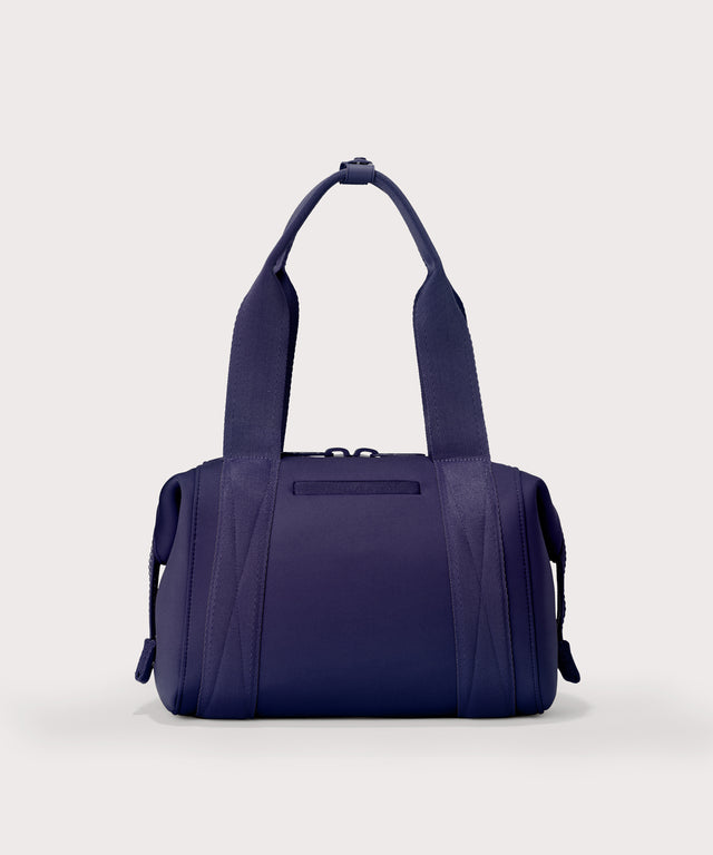 Small Landon Carryall in a jewel-toned, deep blue with strong purple undertones, displaying an exterior phone pocket