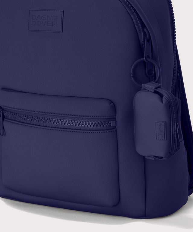 Hunter keychain in a jewel-toned, deep blue with strong purple undertones. front angle showing keychain on a dakota backpack.