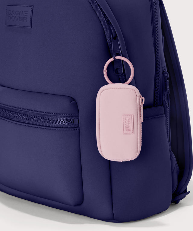 Mara Keychain in a cool, powdery pink with soft grey undertones.  front view. showing keychain on a dakota backpack.