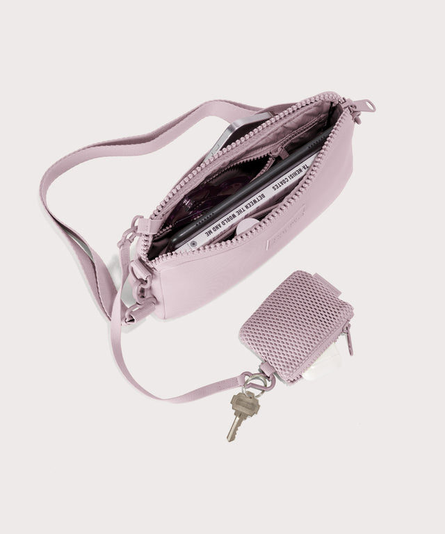 Nora shoulder bag in a cool, powdery pink with soft grey undertones. unzipped, top down view.