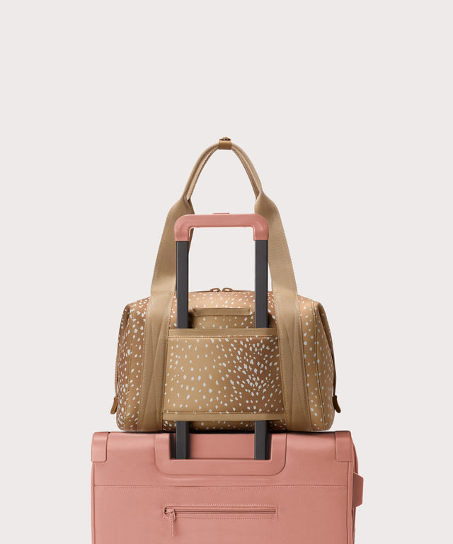 Medium Landon Carryall in an understated, neutral fawn print with a range of rich browns displaying luggage sleeve
