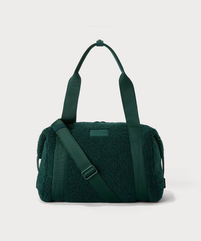 Medium landon carryall in a saturated, jewel-toned deep green with bold blue undertones. In a  Faux Shearling  a soft, wool-like plush made with recycled materials