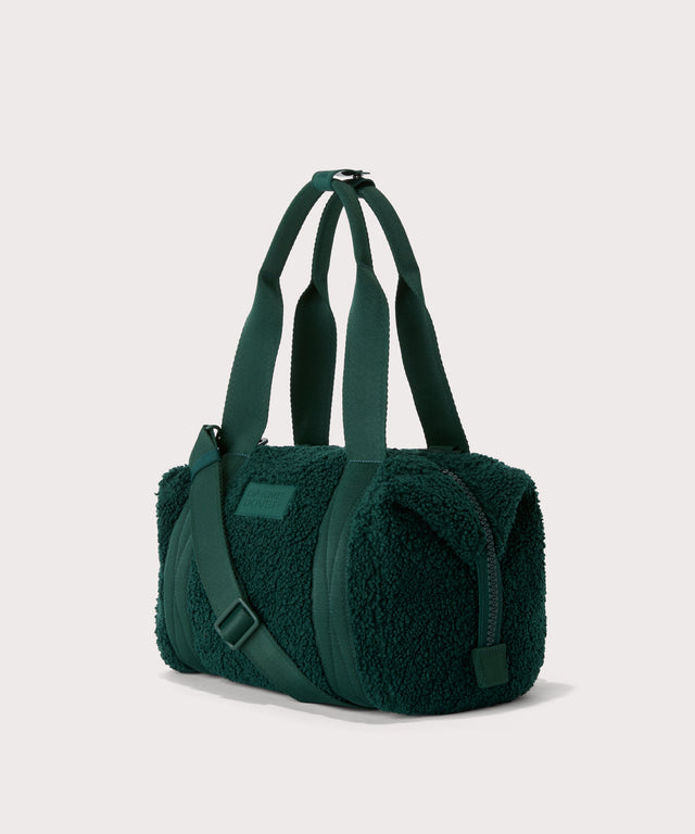 small landon carryall in a saturated, jewel-toned deep green with bold blue undertones..  side angle view  In a  Faux Shearling  a soft, wool-like plush made with recycled materials