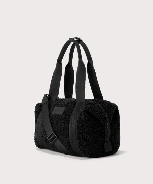 small landon carryall in a black..  side angle view  In a  Faux Shearling  a soft, wool-like plush made with recycled materials