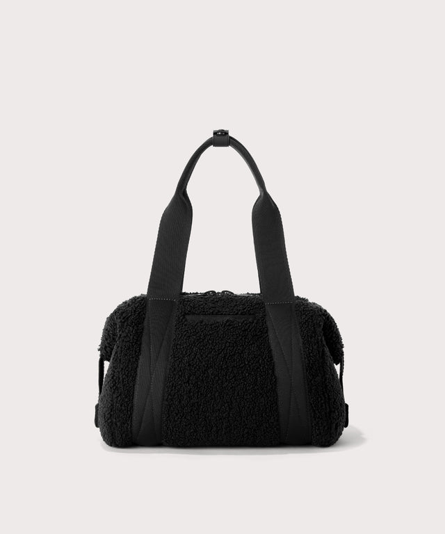 small landon carryall in a black.  Back view.  In a  Faux Shearling  a soft, wool-like plush made with recycled materials