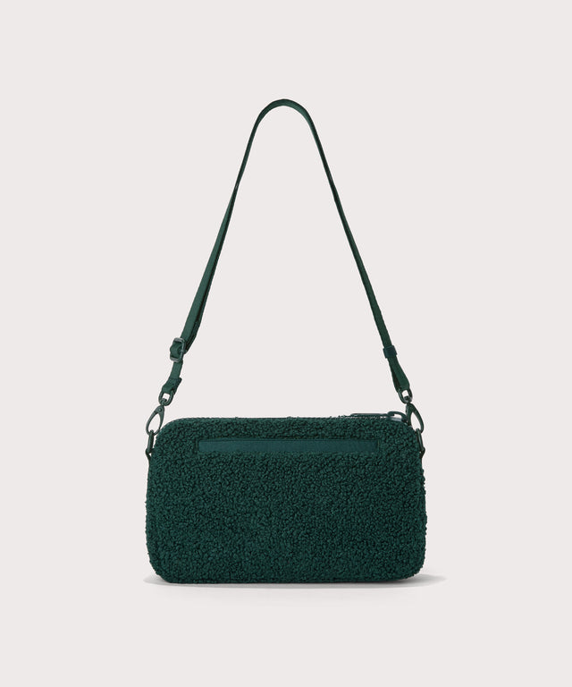 nora shoulder bag in a saturated, jewel-toned deep green with bold blue undertones.  Back view.  In a  Faux Shearling  a soft, wool-like plush made with recycled materials