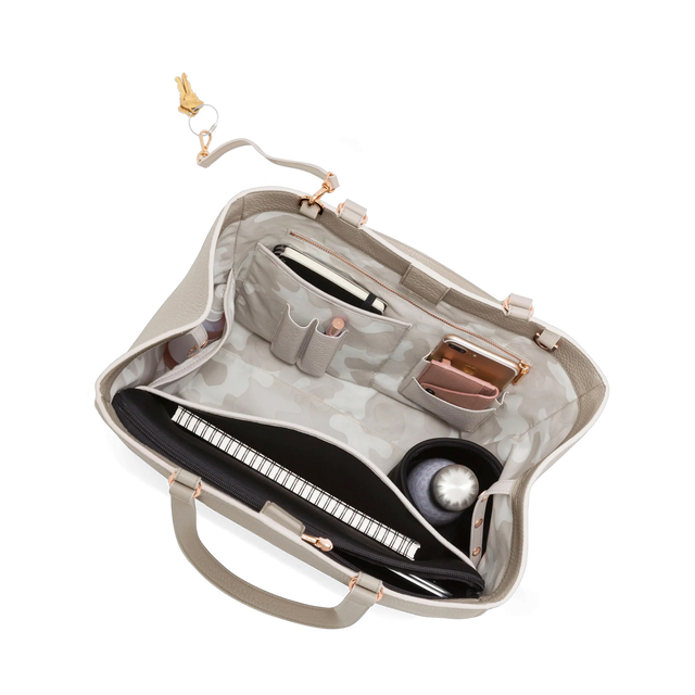 hover - Dagne Dover large Allyn Tote in grey with objects inside the interior pockets.