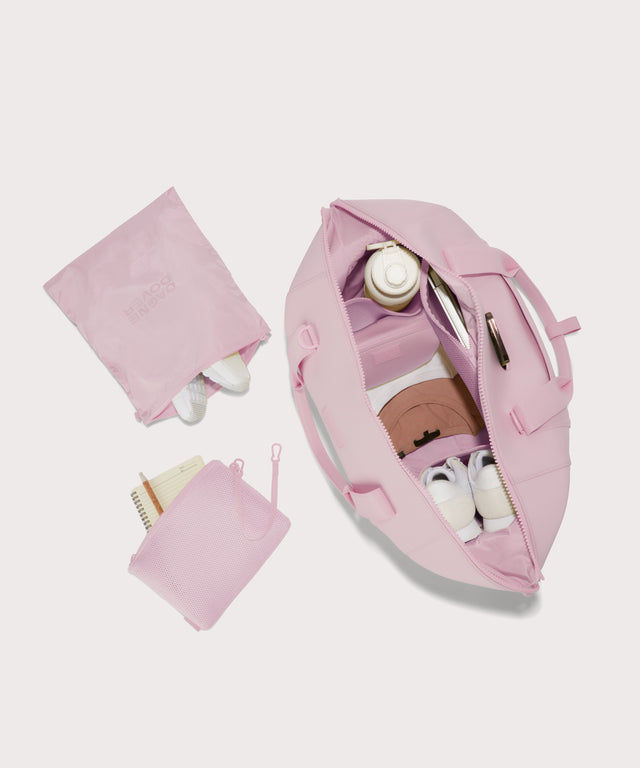 Extra large Landon Carryall in a cool, powdery pink with soft grey undertones unzipped, top down view.