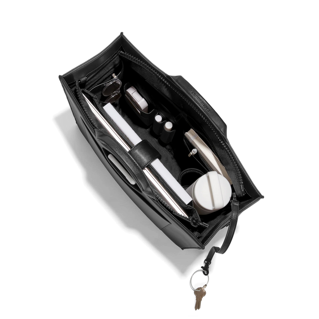 Dagne Dover large vegan Daily Tote in black from above, revealing the interior zipper, interior slip pockets, and padded laptop sleeve.