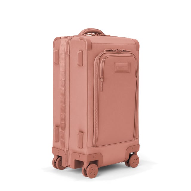 3/4 front view of Seattle carry-on rolling luggage 23.5” in warm dust showing side luggage feet