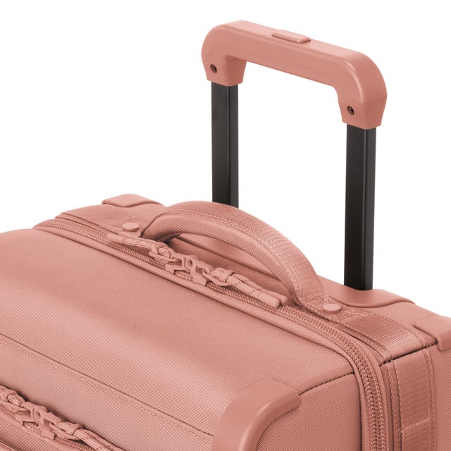 Detail shot of Seattle carry-on rolling luggage 23.5” in warm dust extended luggage handle and puffy handle