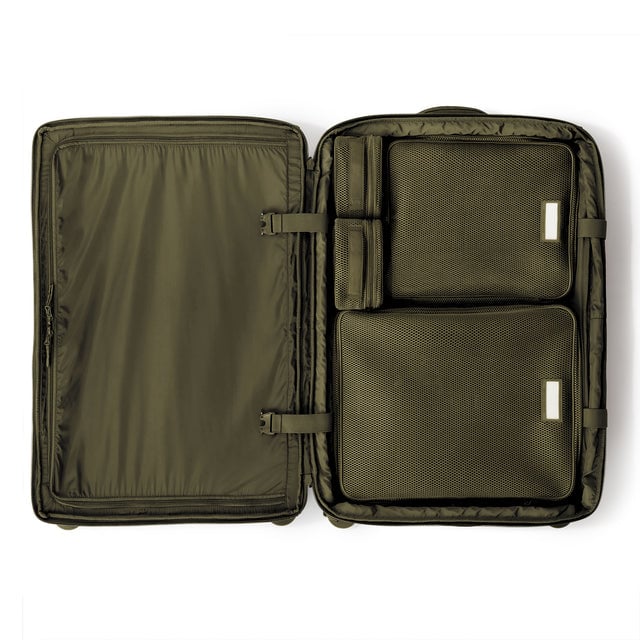 Top down of Sydney checked rolling luggage 28.5” in dark moss with interior divider zipped and packing cubes packed into the right side. hover