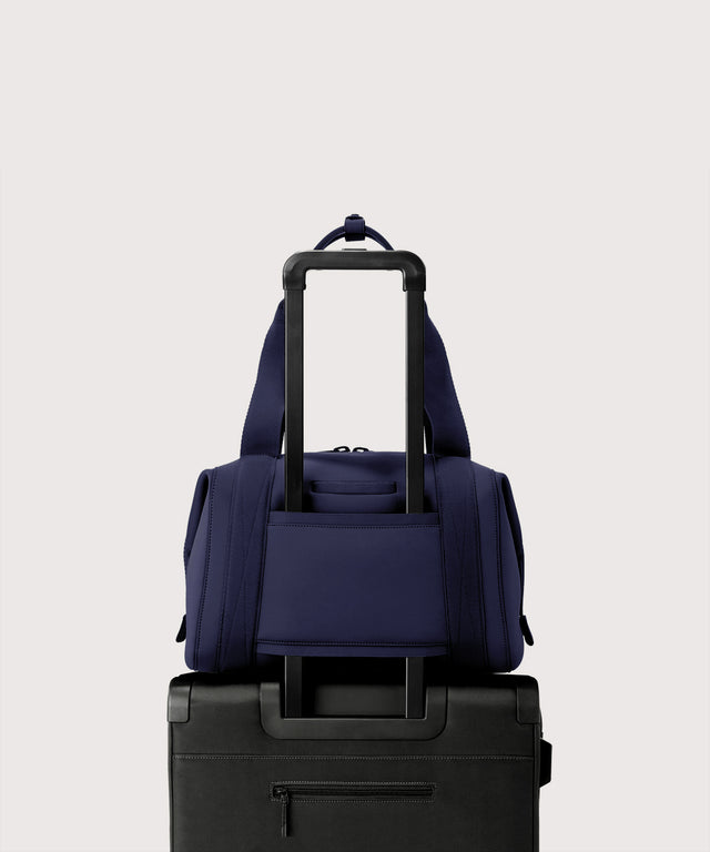 Large Landon Carryall in dark blue displaying luggage sleeve