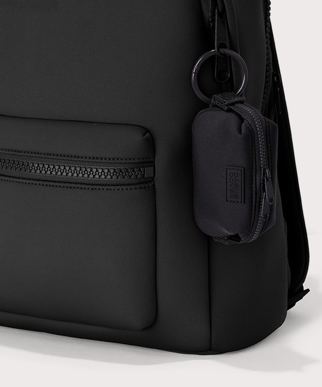 Dagne Dover Hunter Keychain in black clipped onto a backpack.