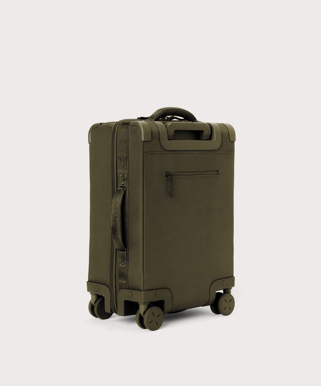 3/4 back view of Seattle carry-on rolling luggage 20.5” in dark green showing side handle and back zippered phone/passport pocket