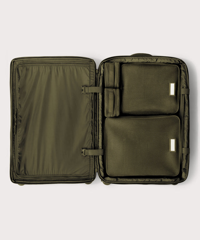 Top down of Sydney checked rolling luggage 28.5” in dark green with interior divider zipped and packing cubes packed into the right side.