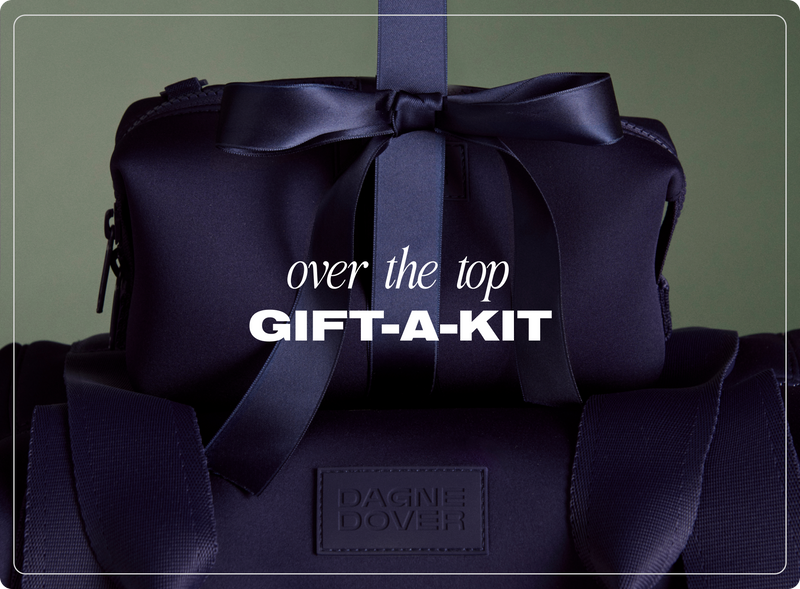 Dark blue gift bag with a bow and 'Dagne Dover' branding on a dark green background. Text says 