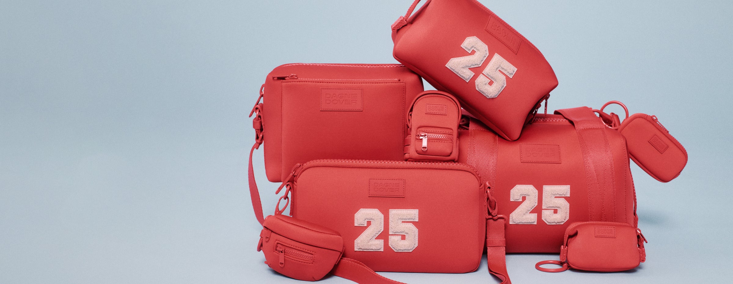 Photos of Dagne Dover model holding Landon Carryall and Hunter Toiletry Bag in new seasonal colors