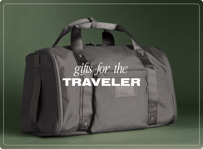 Gray duffel bag with 'gifts for the traveler' text on a green background