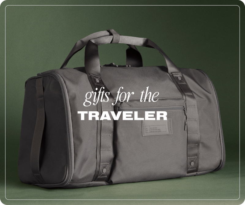 Gray duffel bag with 'gifts for the traveler' text on a green background