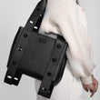 Someone with the Tokyo Turnlock Tote in black slung over one shoulder.
