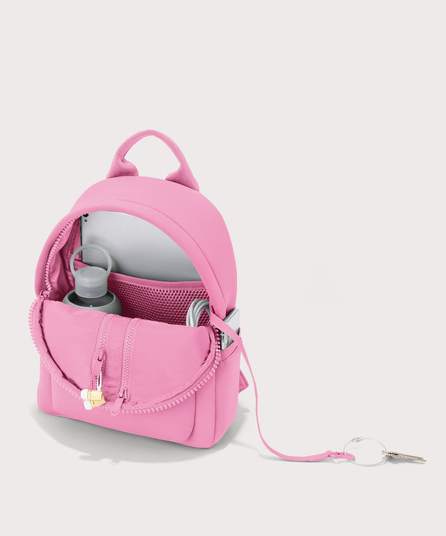 Dagne Dover Small Dakota Neoprene Backpack in a true bubble gum pink unzipped, showing the interior.