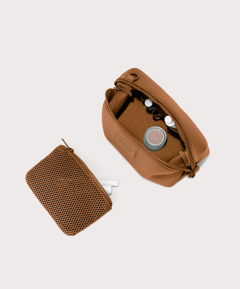Hunter small toiletry bag in a saturated, warm medium-brown with burnt orange undertones. showing exterior airmesh pouch. Top down view.
