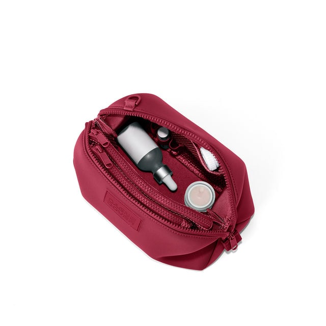 Dagne Dover Large Hunter Toiletry Bag in spice red unzipped and seen from above.