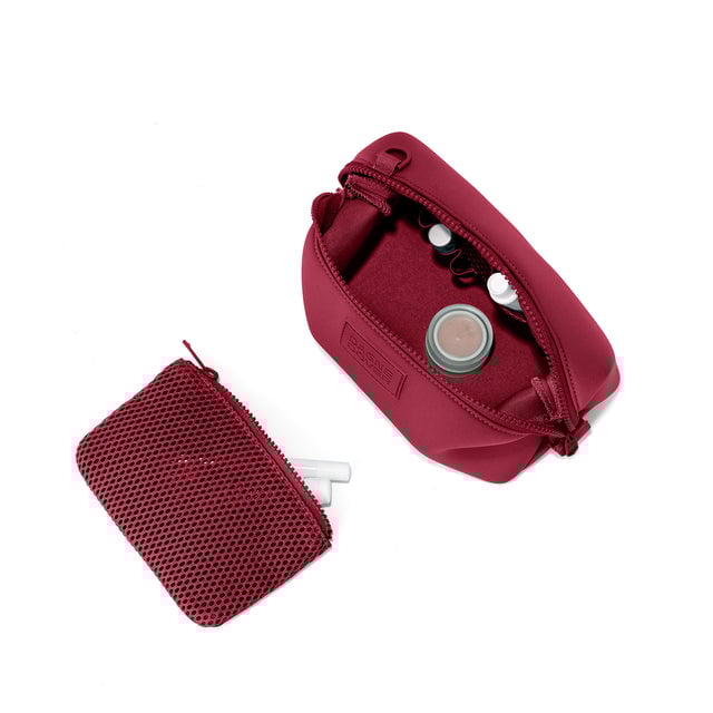 Dagne Dover Small Hunter Toiletry Bag in spice red unzipped and seen from above with the removable air mesh pouch alongside it. hover