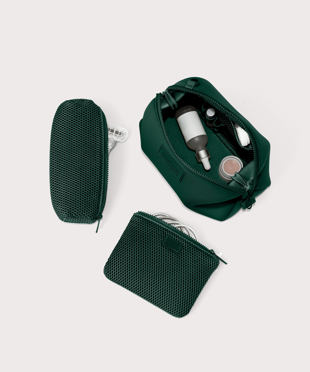 Hunter Large toiletry bag in a saturated, jewel-toned deep green with bold blue undertones unzipped, top down view. 
