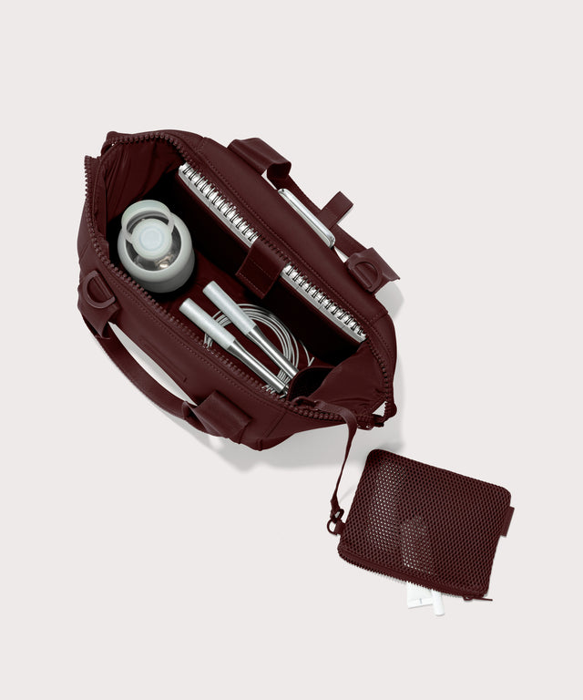 Dagne Dover Small Landon Carryall in a deep brown with purple undertones unzipped, top down view.