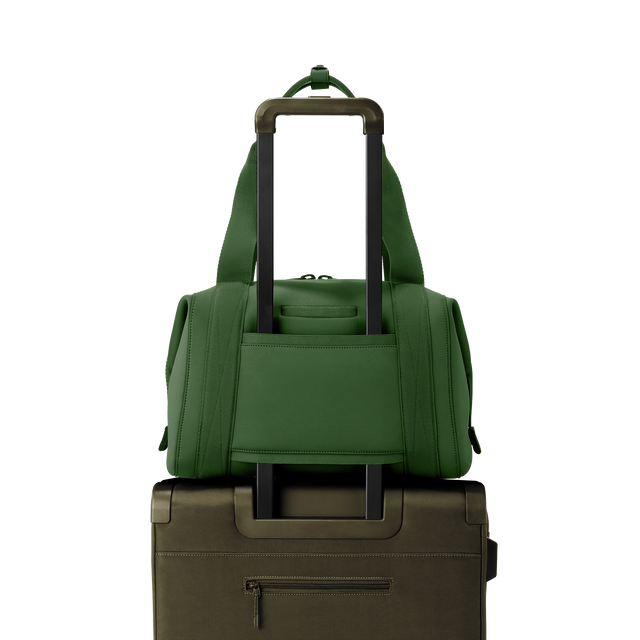 Dagne Dover medium Landon Carryall in a rich, classic forest green displaying luggage sleeve.
