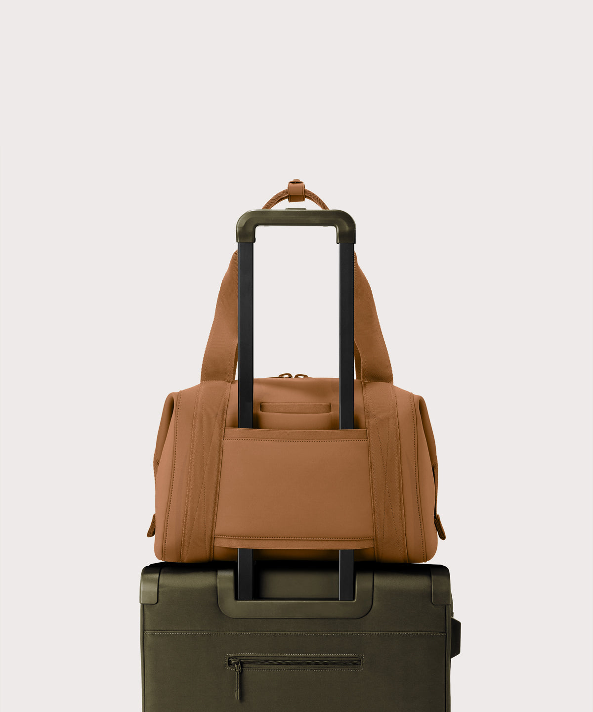 Medium Landon Carryall in a a saturated, warm medium-brown with burnt orange undertones displaying luggage sleeve
