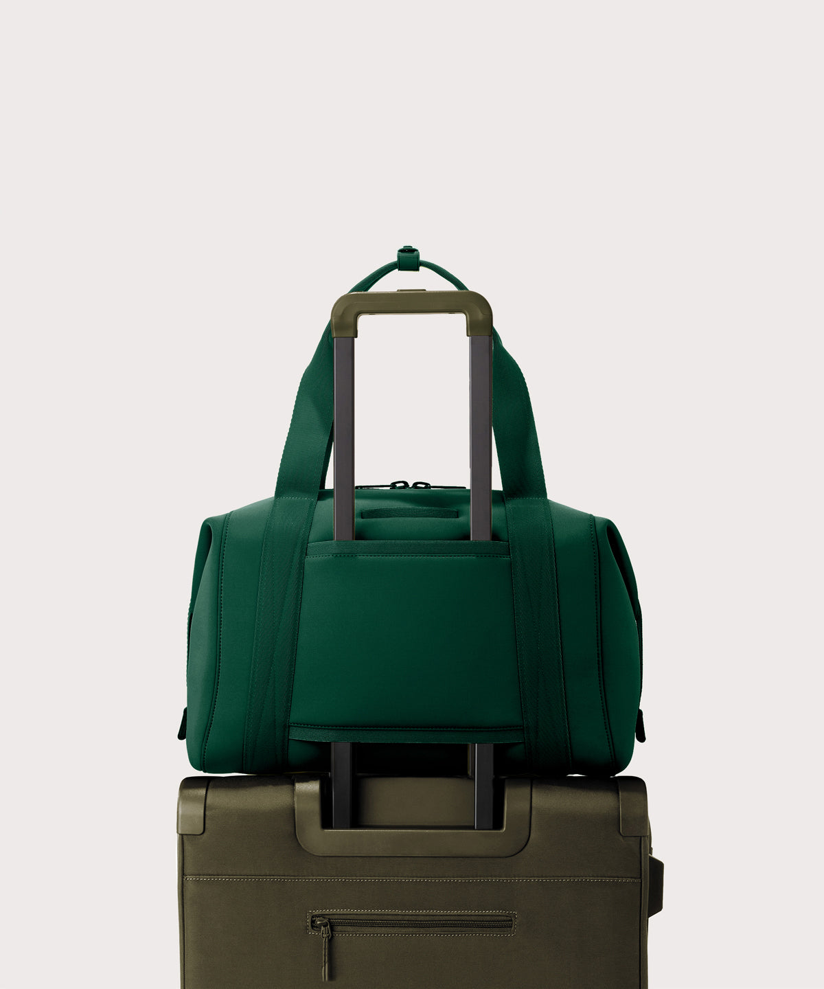 Large Landon Carryall in a saturated, jewel-toned deep green with bold blue undertones. displaying luggage sleeve
