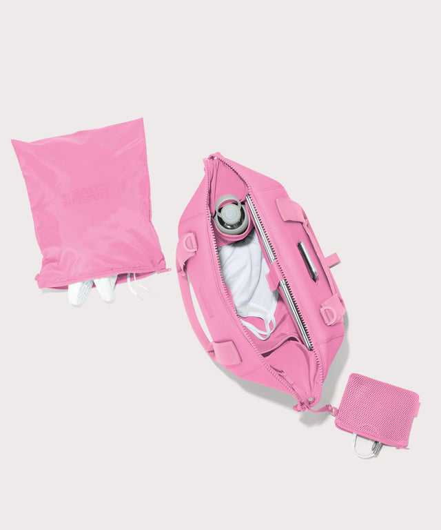 Dagne Dover Medium Landon Carryall in a true bubble gum pink unzipped, top down view.