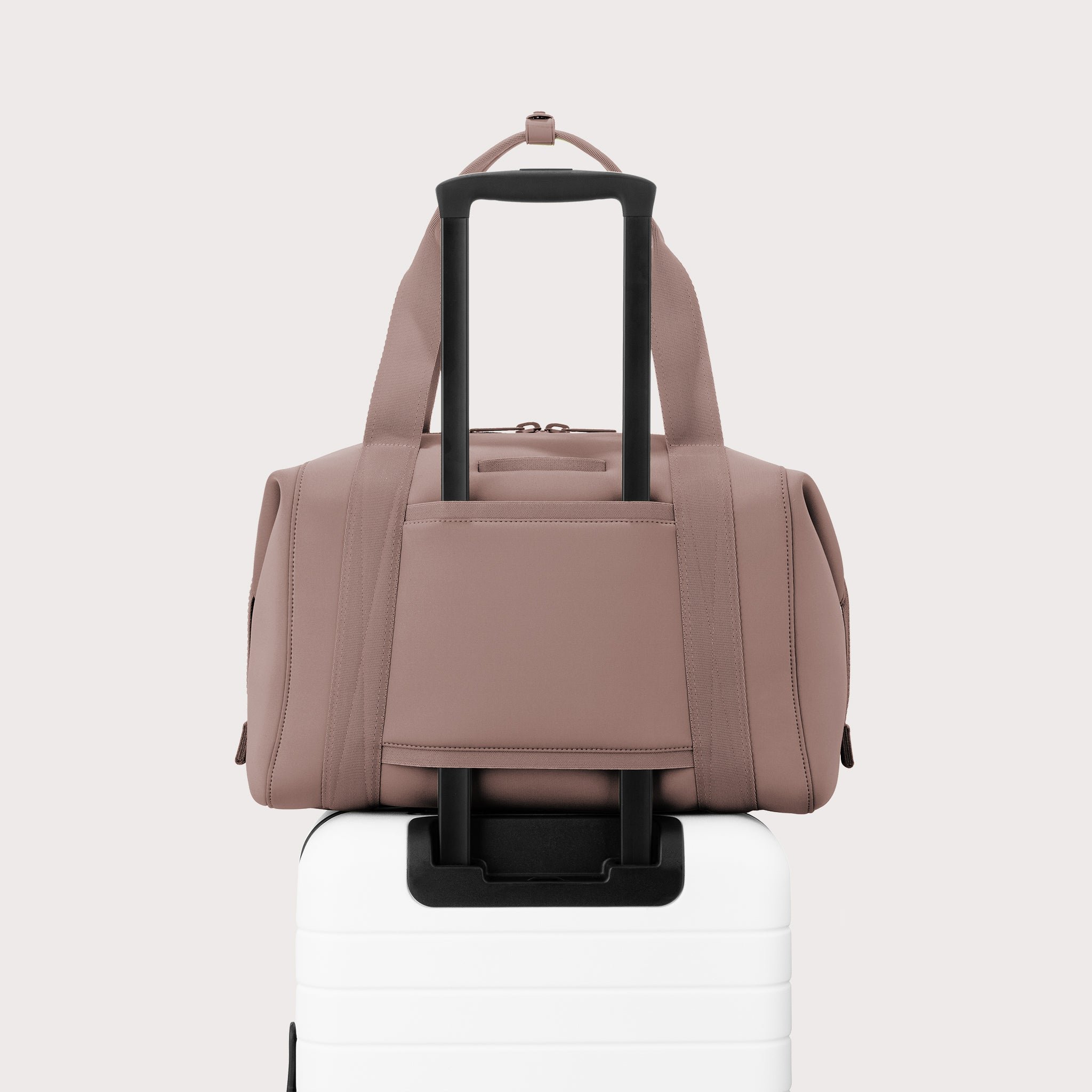 Large Landon Carryall in pink displaying luggage sleeve
