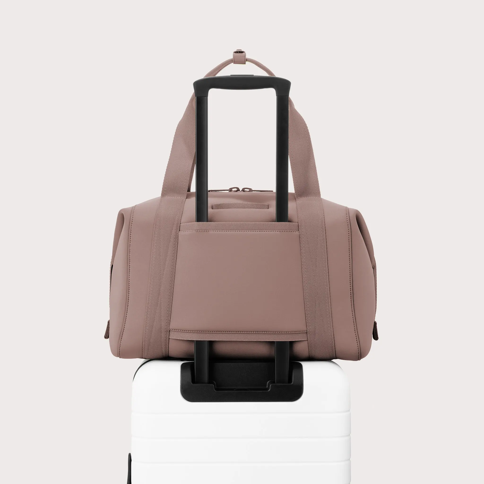 Large Landon Carryall in pink displaying luggage sleeve