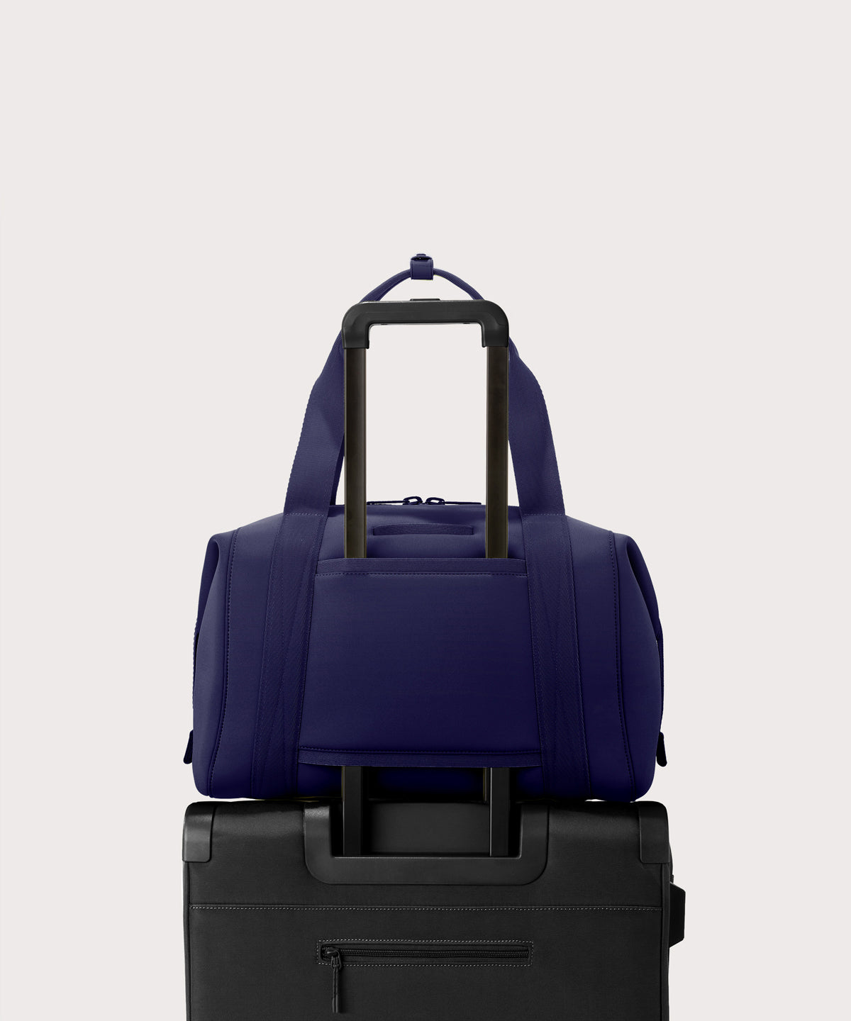 Large Landon Carryall in a jewel-toned, deep blue with strong purple undertones displaying luggage sleeve

