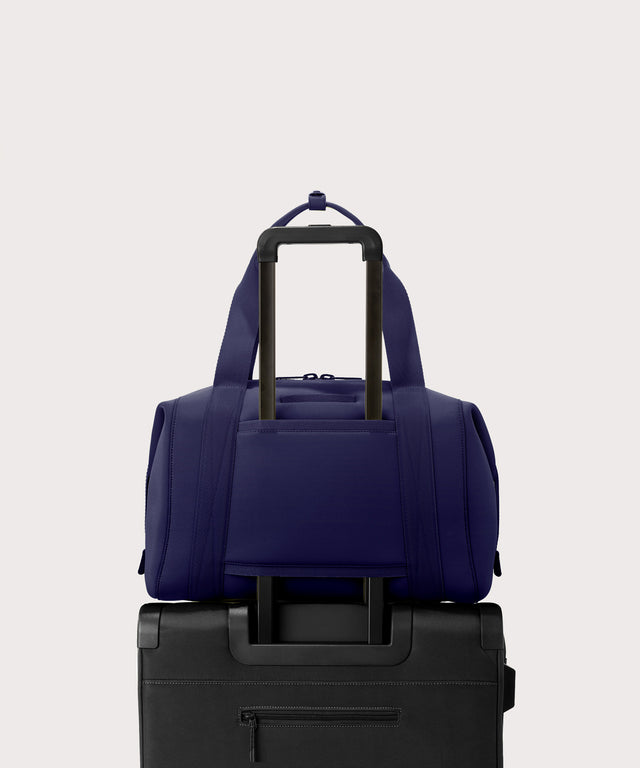Large Landon Carryall in a jewel-toned, deep blue with strong purple undertones displaying luggage sleeve
