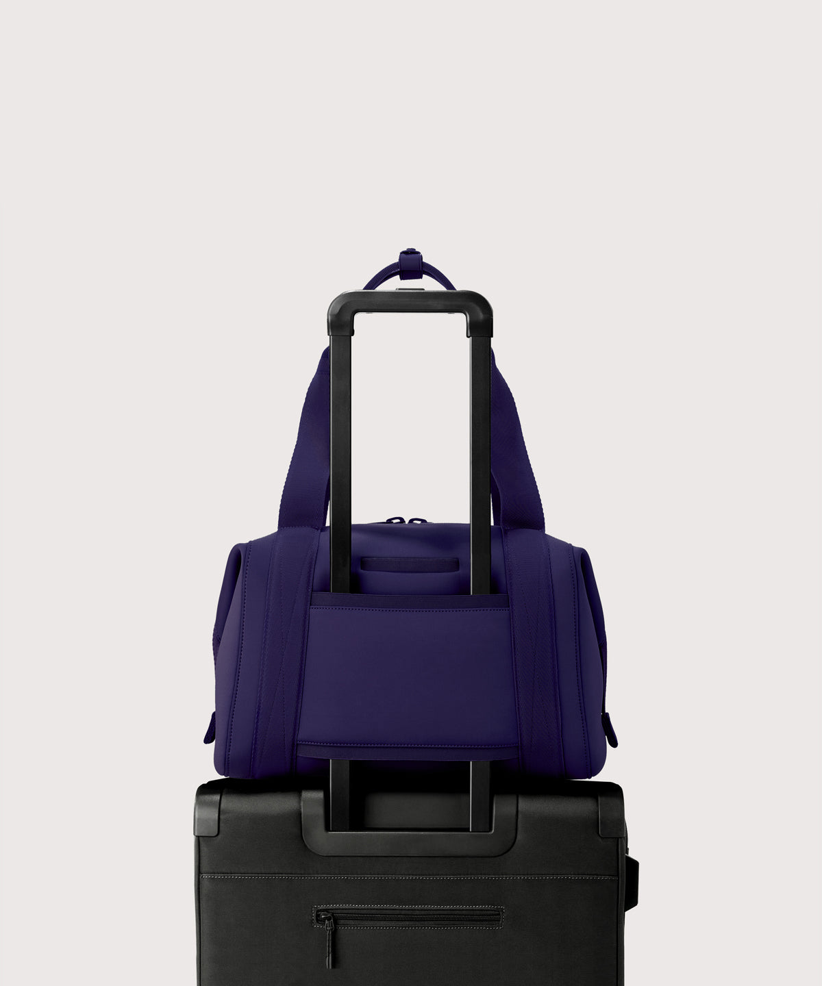 Medium Landon Carryall in a jewel-toned, deep blue with strong purple undertones displaying luggage sleeve
