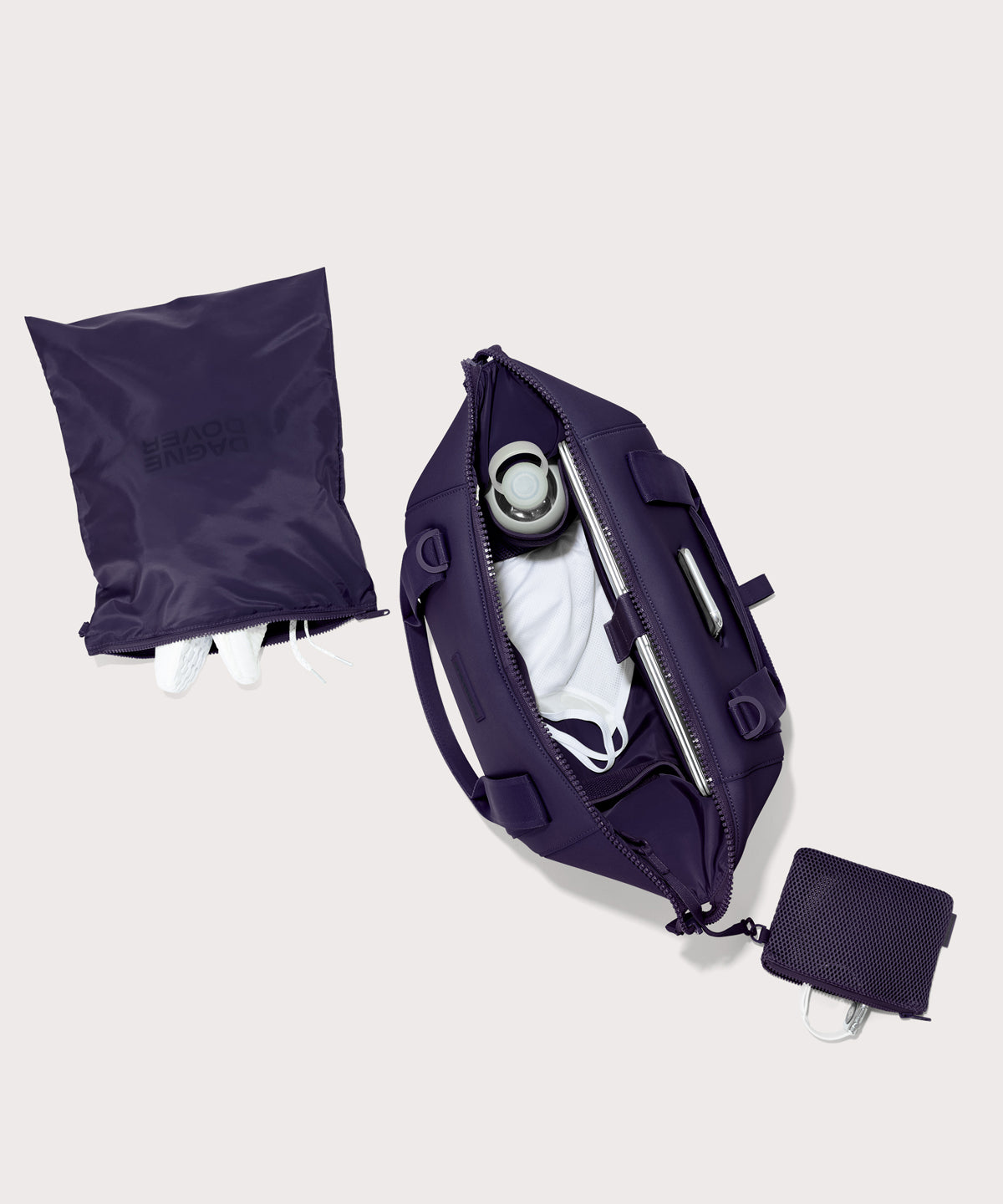 Medium Landon Carryall in a jewel-toned, deep blue with strong purple undertones unzipped, top down view. 
